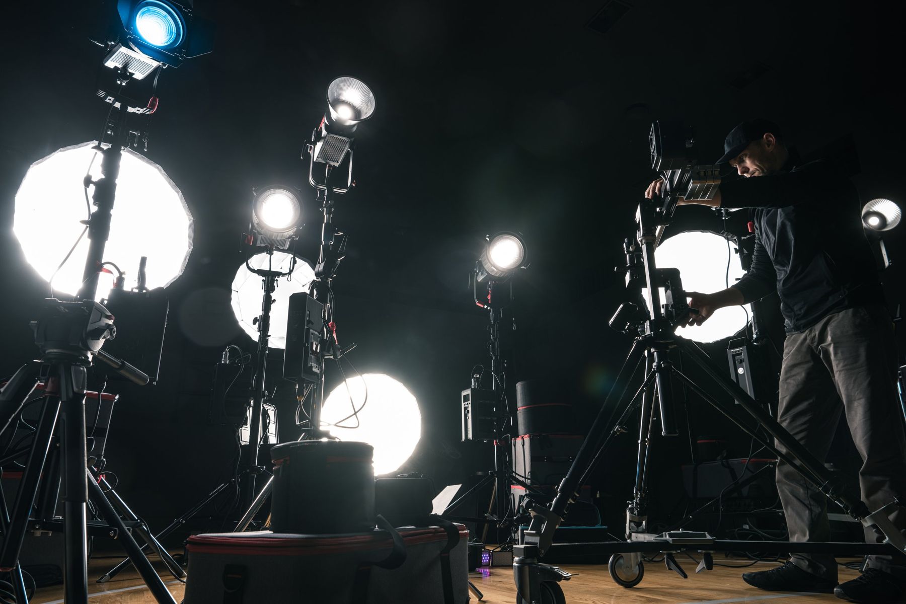 Filmmaker adjusting lighting on set